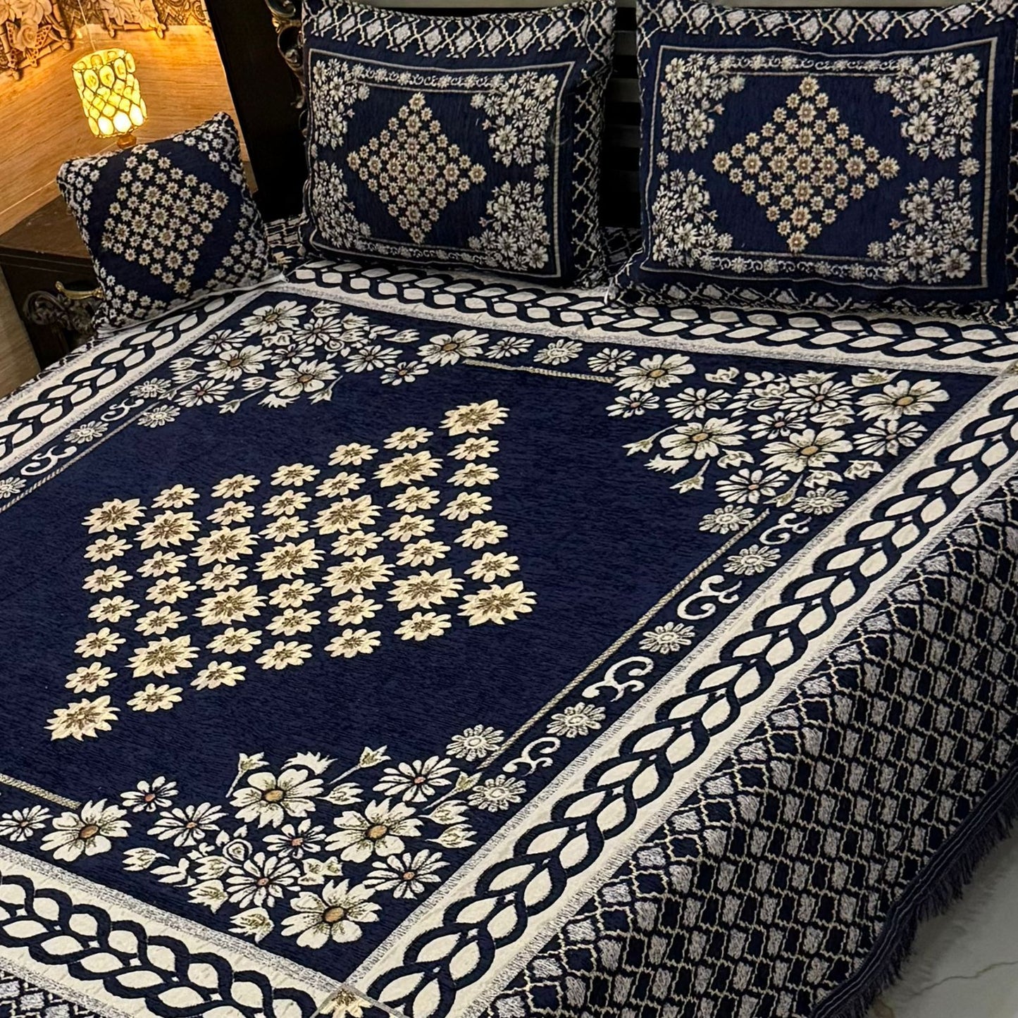 4Pc Velvet Jacquard King Size Bedsheet Set with navy blue floral design, includes 1 bedsheet, 2 pillow covers, and 1 cushion cover. Available in 70+ designs and colors. 100% color guaranteed.